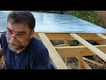 Installing metal corrugated roofing on the goat barn