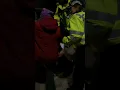Little old lady protester being Arrested but walking to the van