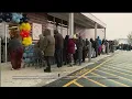 Local residents stand out in the cold as new ALDI store opens