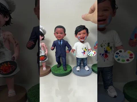 A row of handmade clay dolls shaking with happy faces.