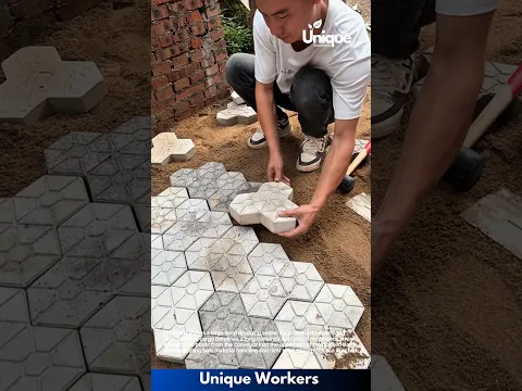 Paver Installation: Man Laying Interlocking Tiles on Sand