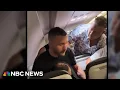 Passengers restrain man accused of trying to enter cockpit mid-flight