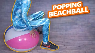 pop inflatable popping with a beach ball in front of the iw seal