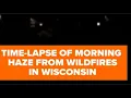 Haze from wildfires descend on Wisconsin in time-lapse