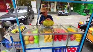 A Thai girl cutting a giant fruit