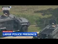 1 taken into custody as military-style armored police vehicles surround McHenry home
