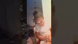 Laynie and Janai decorating their Gingerbread Nativity Scene on Christmas Eve