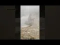 2nd of a man near thermal feature in Yellowstone National Park