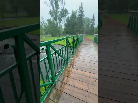 A Green Metal Bridge Crossing Over a River