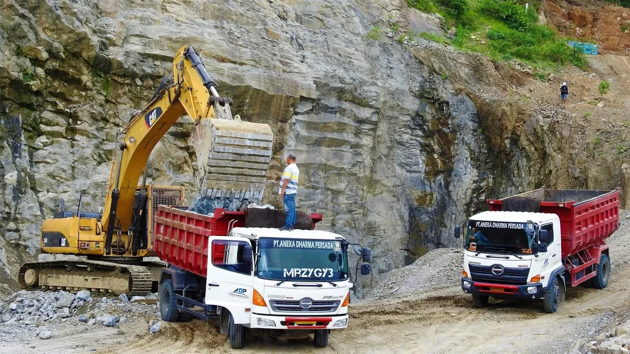 Excavator Loading Rock Into Dump Truck After Blasting