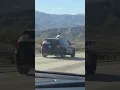 A of a passenger sticking out of the sunroof in the Cajon Pass