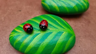 Lady bug on leaf stone painting Rock Painting Tutorial For Beginners Ladybug