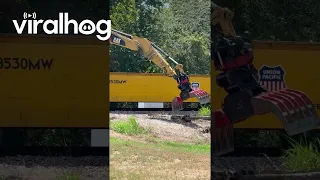 Train-Mounted Excavator Removes Debris From Tracks || ViralHog