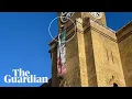 Download Lagu 'Freedom for Iran' protester on top of King's Cross station holding dog