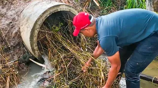 Unclogging a Deep Culvert Drain Packed with Debris