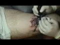 Eric Newby tattooing a TARANTULA