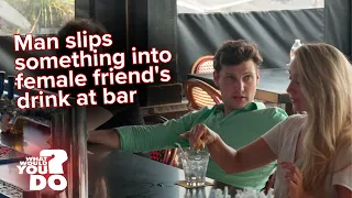 young man spikes a woman s drink at a bar