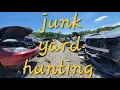 Looking for parts at the pull-a-part junkyard flipping parts