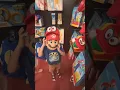 Trying on kids Super Mario costume