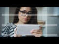 Mature brunette businesswoman in glasses and striped blouse with digital tablet at office