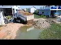 Download Lagu Project to add soil to control floodwaters uses a small water pump to push soil from a 5-ton truck.
