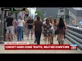 Concert goers dodge traffic weather downtown