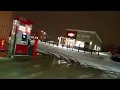Walking Through the Snow Past the Gas Station Outside of Fastrac at the Corner of Dewey Avenue
