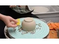 Using a CI Sticky Bat to trim a bowl on the potter s wheel