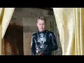 Macaulay Culkin running w electric chainsaw in gimp suit