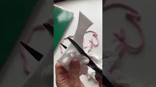 Artist creates a sheep decoration using wire and cotton cord