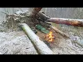 Lagu Schuil in de sneeuwstorm tussen omgevallen bomen met een kampvuur. Solo Bushcraft Survival