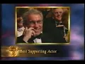 Bra-less Liz Hurley befuddles Billy Connolly at the BAFTAs!