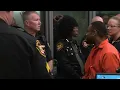 Man accused of killing deputy gestures to supporter at arraignment