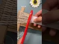 Homemade cardboard loom to make a small rainbow-colored scarf fun and