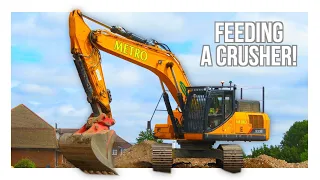 excavators feeding a crusher diggers and dozers