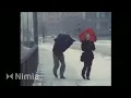 Download Lagu couple with umbrellas walking in strong wind and snow