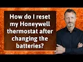 How do I reset my Honeywell thermostat after changing the batteries