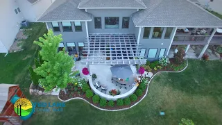 Beautiful Backyard Outdoor Living - Stone Patio Fire Pit Pergola Plantings in Central Iowa