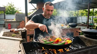 GRILLED MEAT with VEGGIES on a FRYING PAN.