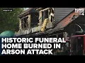 Suspect seen on camera apparently setting historic funeral home on fire
