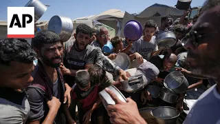 Palestinians desperate to eat crowd around volunteers distributing meals in Gaza