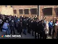 Returning Auschwitz survivors say never allow history to repeat
