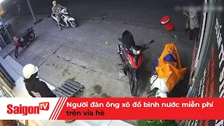 Người đàn ông xô đổ bình nước miễn phí trên vỉa hè | Tin tức SaigonTV