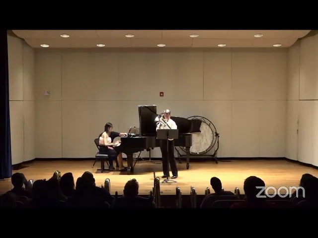A soloist and pianist performing on stage