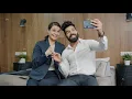Man and woman colleagues taking selfie in hotel room posing for smartphone camera