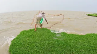 Grandfather fishing in rainy day in river - net fishing in river - amazon fishing video