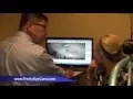 Dr Albert Pang shows x-rays to one of his patients at Trinity Eye Care in Plano Texas