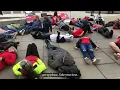 Protestors at Scotland 2022 take part in a mass lie down