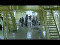 Jail surveillance - Brandon Daniel bows pumps fist following news coverage of shooting on Aug