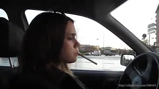 nice girl smoking in the car while driving